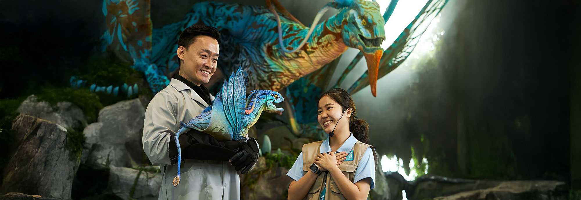 Tour guide holding animatronic banshee on arm and showing to visitor