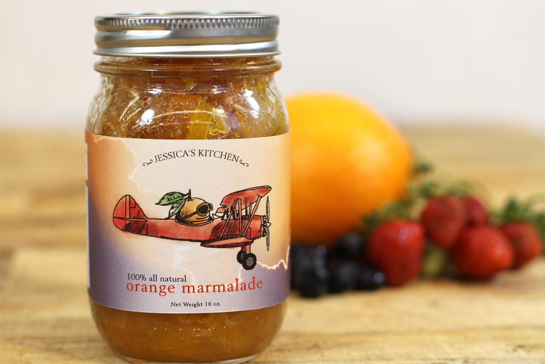 Orange marmalade photographed with fruit on the side