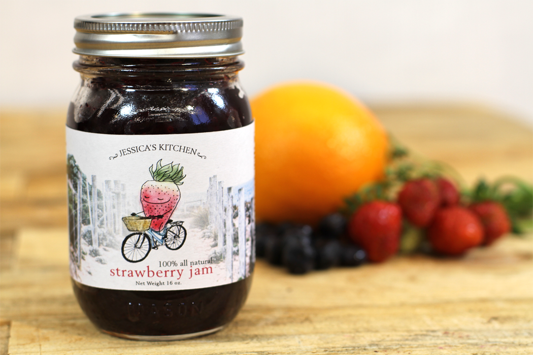 Strawberry jam photographed with fruit on the side