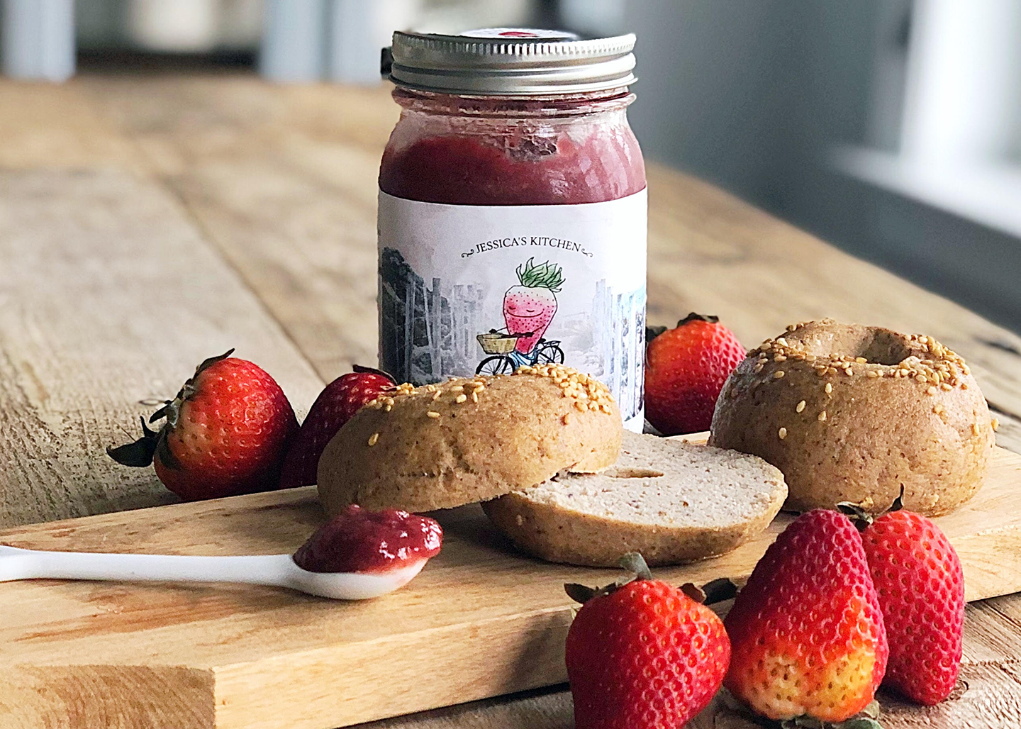 Strawberry jam photographed with whole wheat bagels