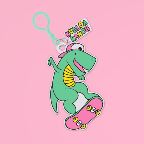 PVC Keychain of a green T-rex with a backwards cap on a skateboard